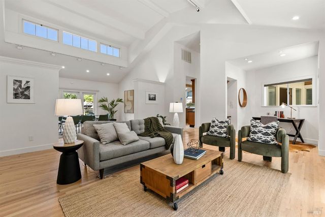 a dining room with furniture and wooden floor