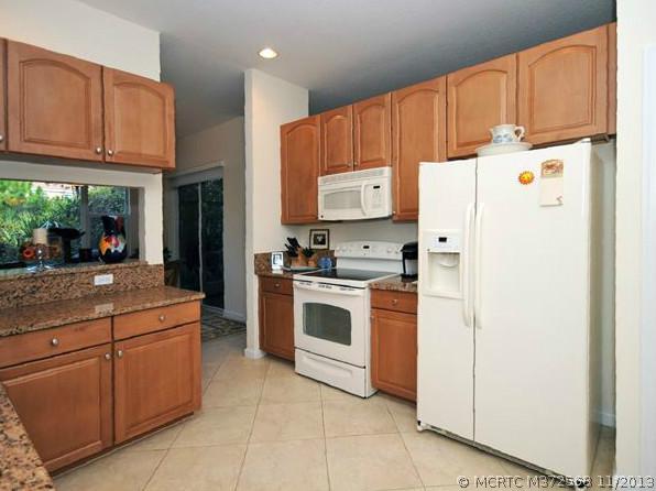 134 Southwest Walking Path Stuart, FL 34997 - Photo 5 of 25 Kitchen. 42" Maple Cabinetry, Tile on the diagonal, GE Appliances, Granite Counters, Brushed Nickel Knobs