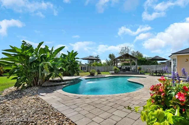 a view of a swimming pool with a yard