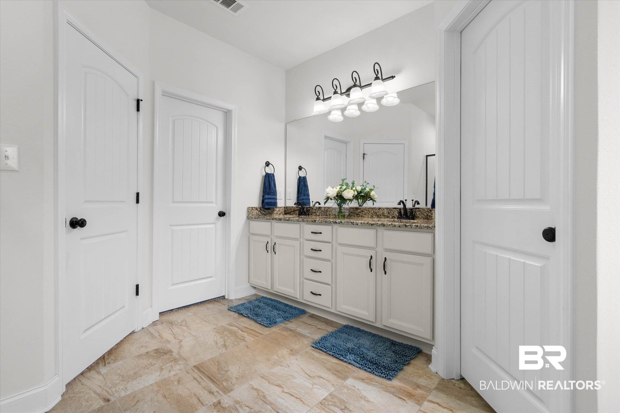 1270 Surrey Loop Foley, AL 36535 - Photo 17 of 27 Double vanity with a granite countertop, dual undermount sinks, and matte black fixtures