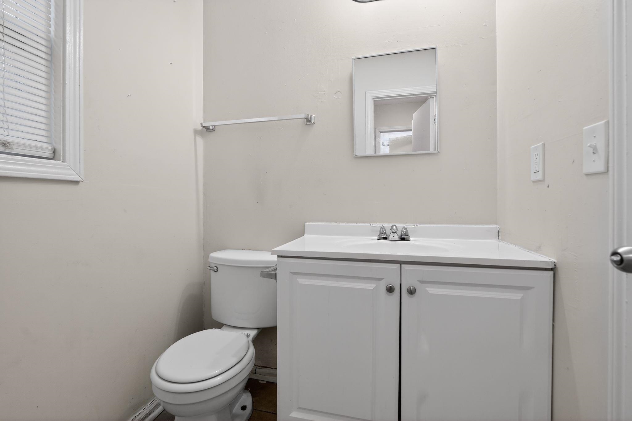 4725 Lofts Road Memphis, TN 38118 - Photo 21 of 32 a bathroom with a sink a toilet and a mirror