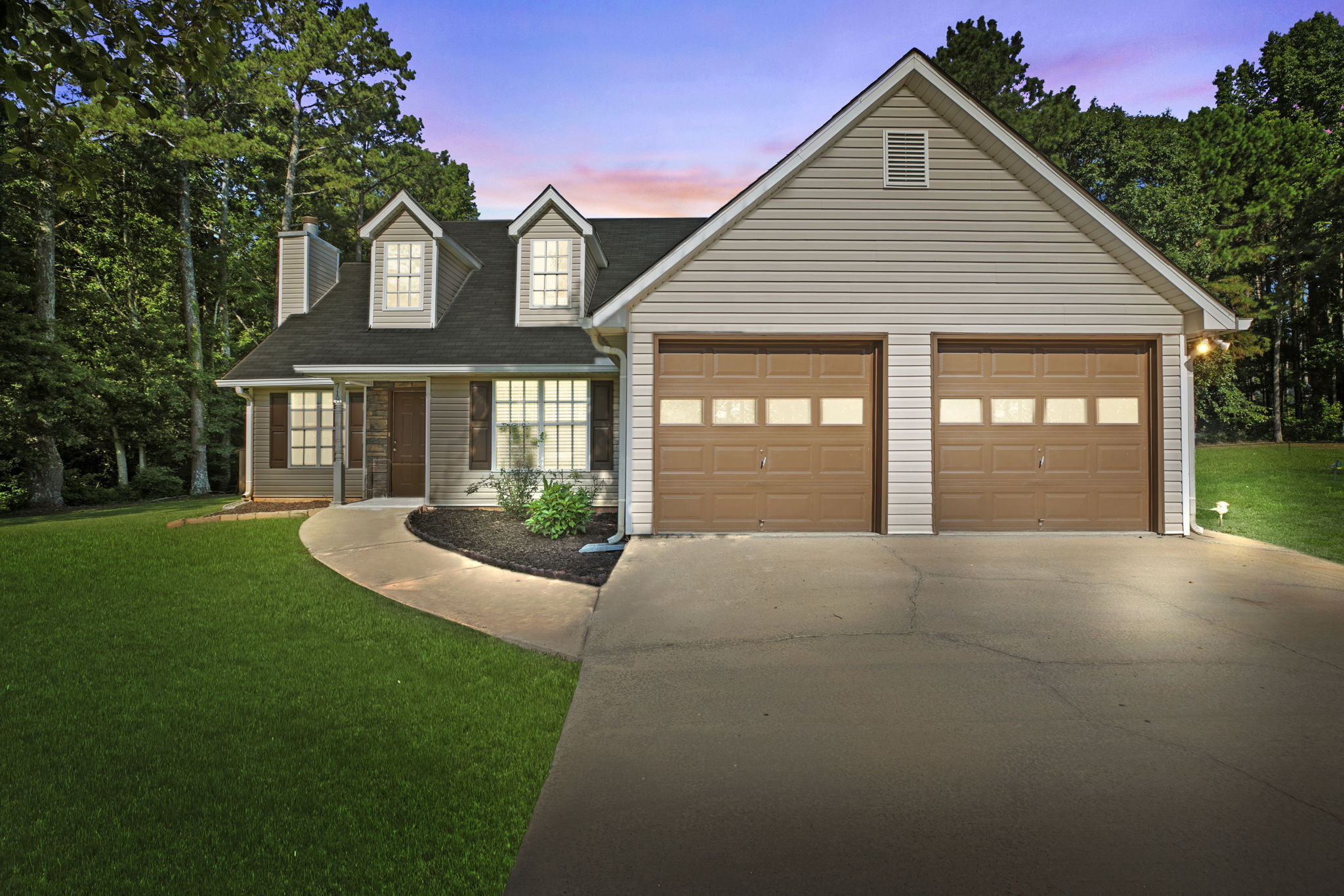 a front view of a house with a yard and garage