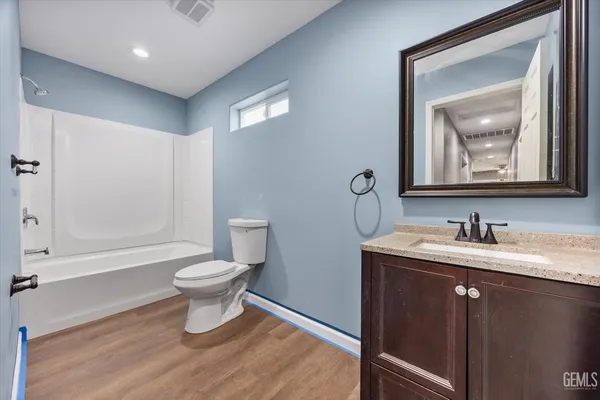a bathroom with a toilet a sink and a mirror