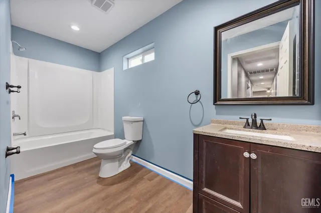 a bathroom with a toilet a sink and a mirror