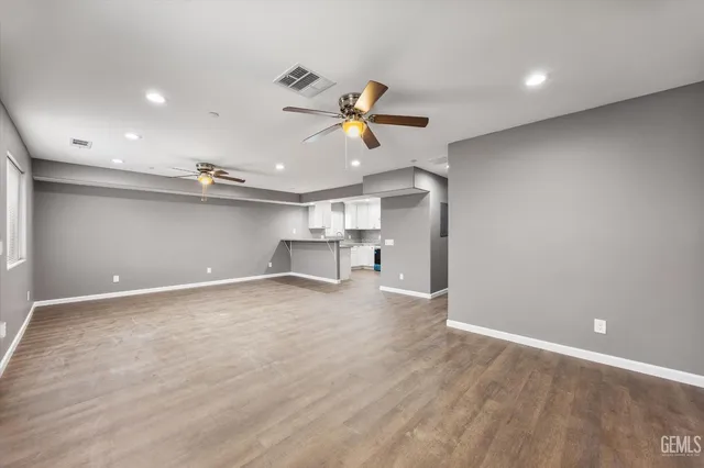 a view of a empty room with a ceiling fan