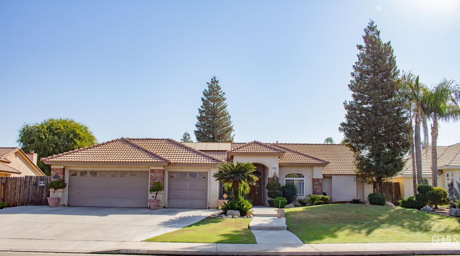 Undisclosed Address Bakersfield, CA 93313 - Photo 1 of 17 a front view of a house with garden