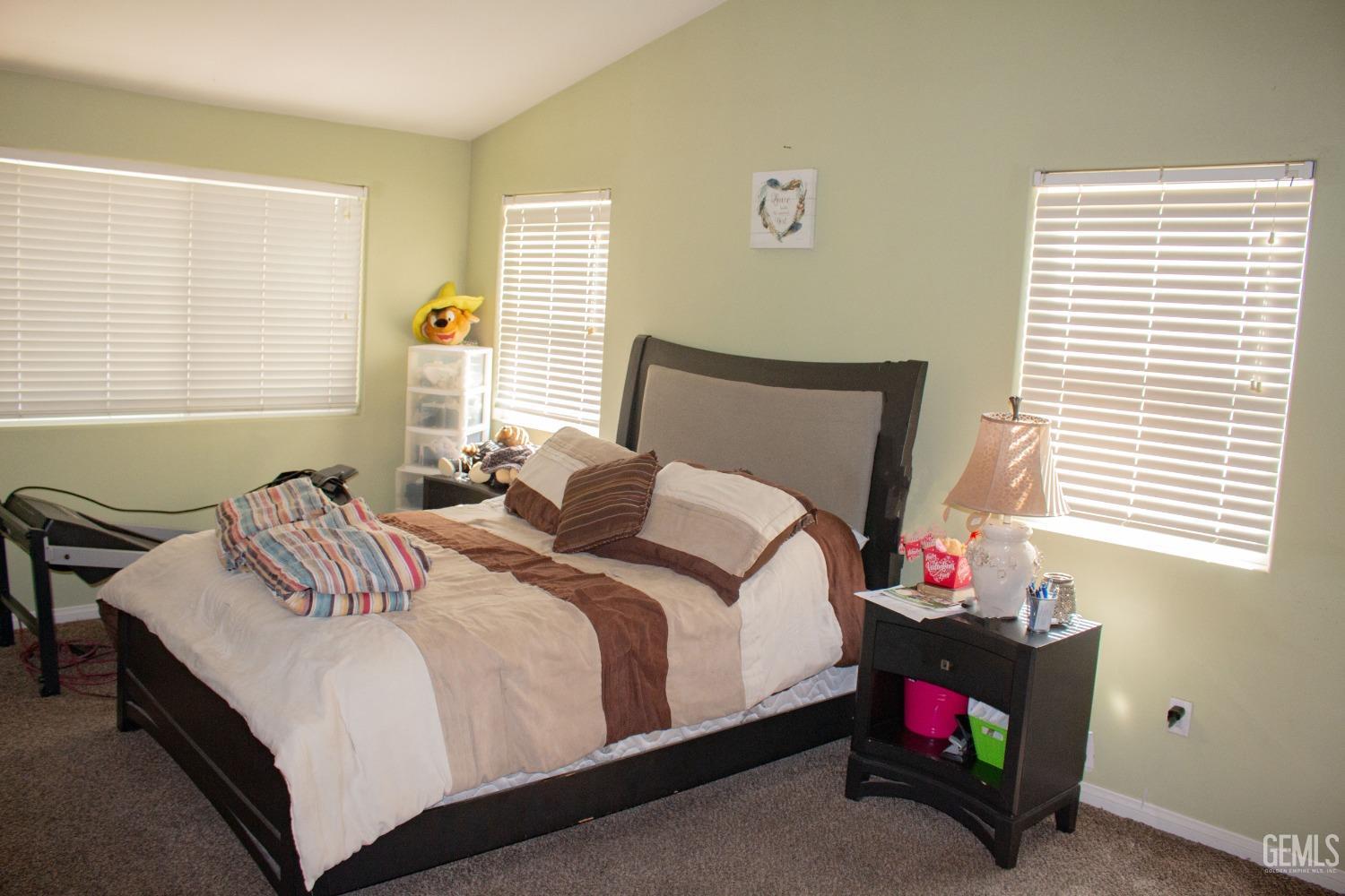 Undisclosed Address Bakersfield, CA 93313 - Photo 12 of 17 a bedroom with a bed and a window