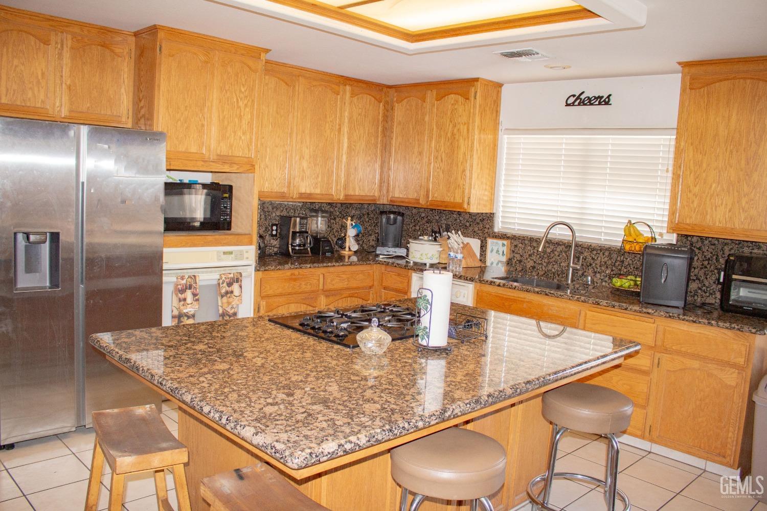 Undisclosed Address Bakersfield, CA 93313 - Photo 5 of 17 a kitchen with stainless steel appliances granite countertop a sink counter space and a window