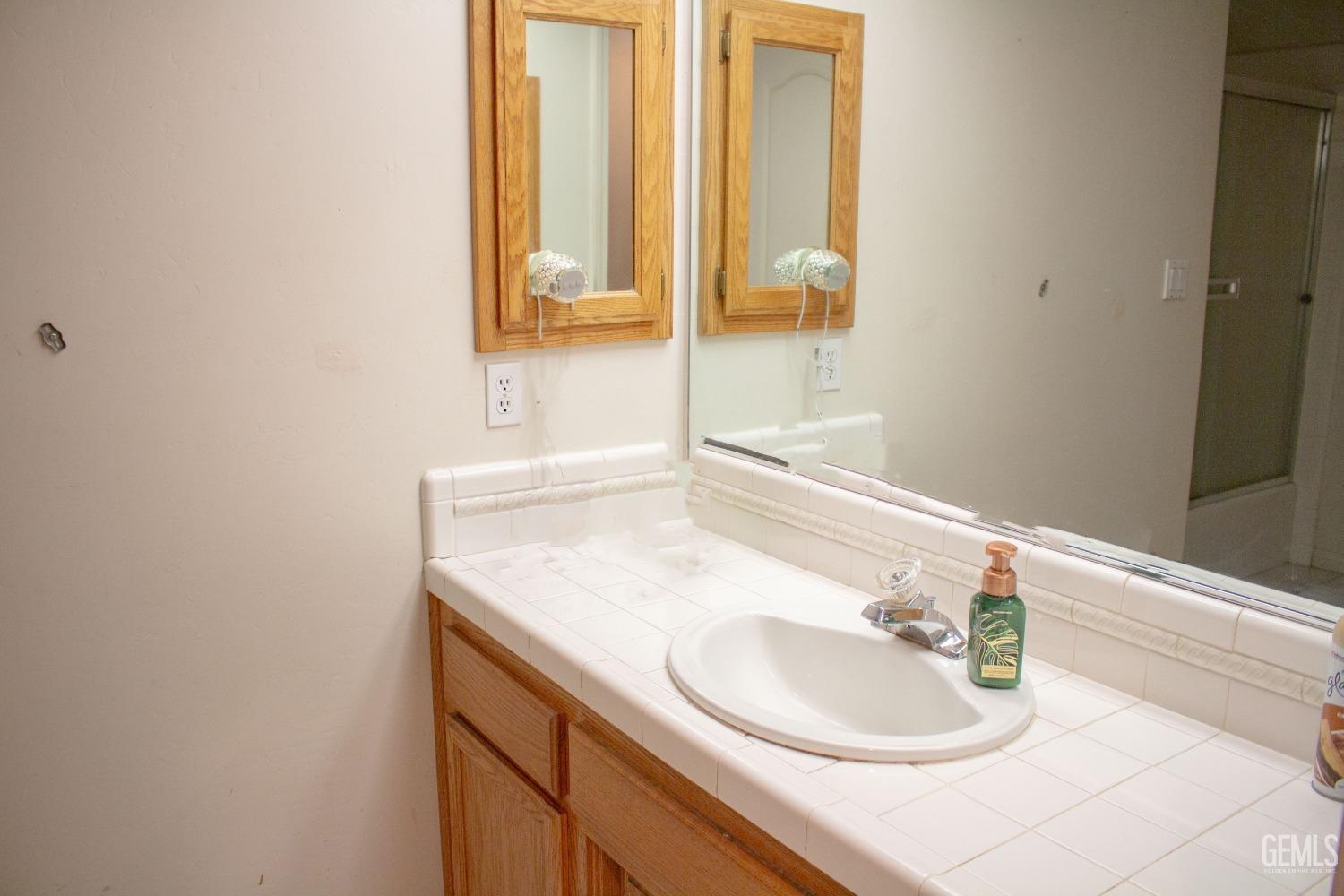 Undisclosed Address Bakersfield, CA 93313 - Photo 8 of 17 a bathroom with a sink and a mirror