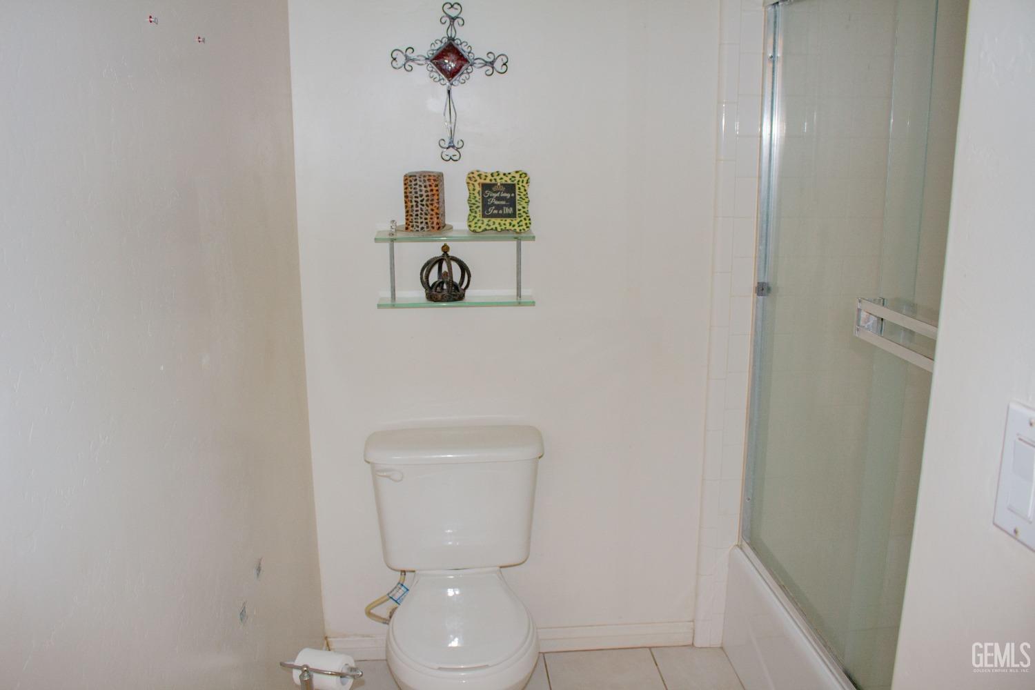 Undisclosed Address Bakersfield, CA 93313 - Photo 9 of 17 a bathroom with a toilet and a sink