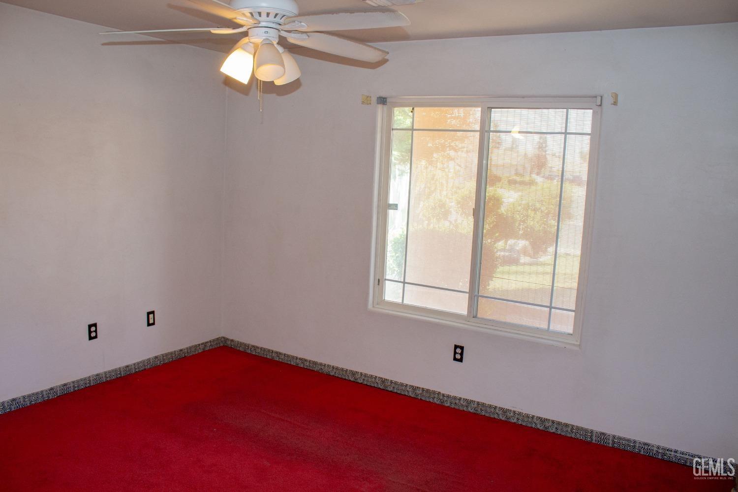 Undisclosed Address Bakersfield, CA 93313 - Photo 10 of 17 an empty room with windows and fan
