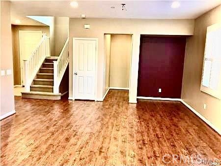 4473 Bigem Court Riverside, CA 92501 - Photo 11 of 20 an empty room with wooden floor and windows