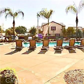 4473 Bigem Court Riverside, CA 92501 - Photo 2 of 20 a view of a swimming pool with a table and chairs