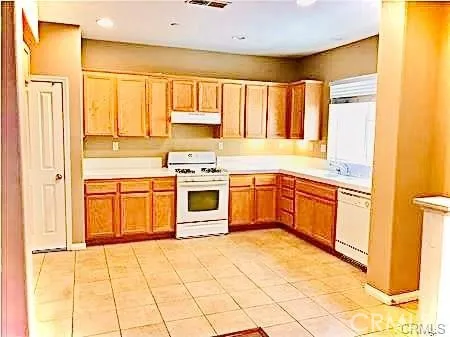 a kitchen with stainless steel appliances granite countertop a stove sink and cabinets