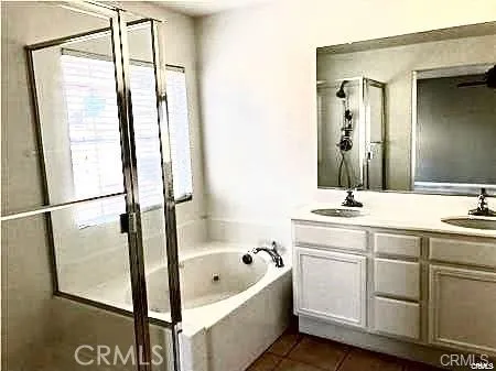 a bathroom with a tub sink and mirror