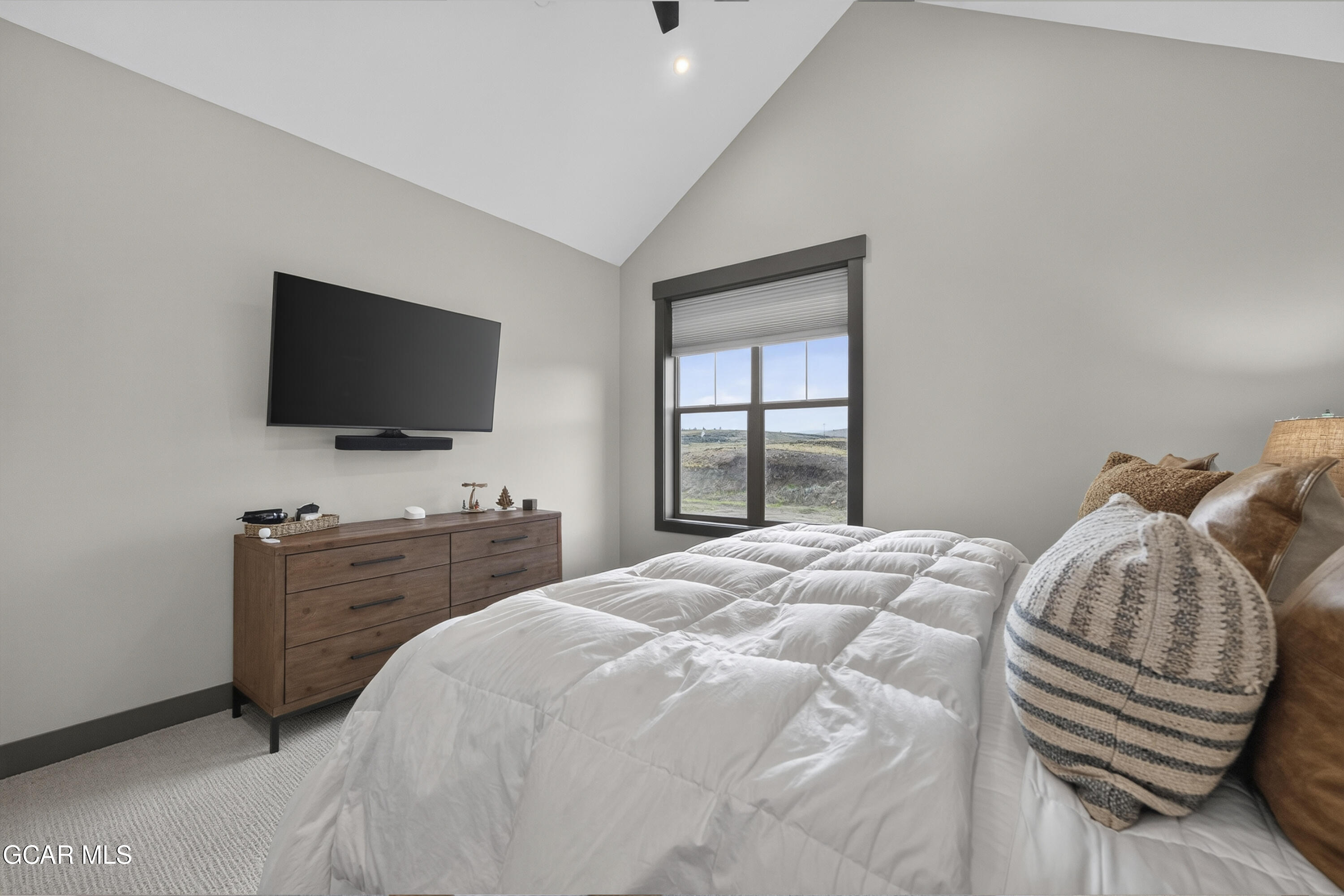 154 Eagle Ridge Drive Granby, CO 80446 - Photo 30 of 59 a bedroom with a bed and a flat screen tv