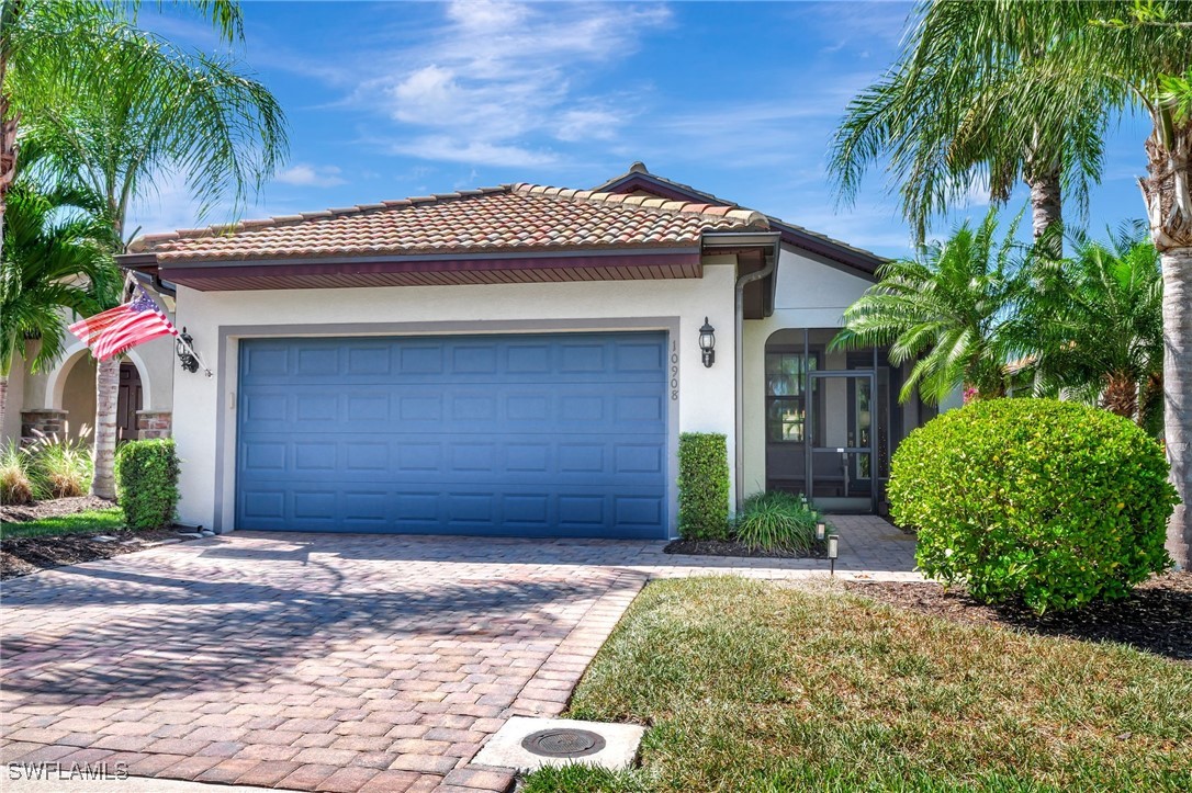 10908 Clarendon Street Fort Myers, FL 33913 - Photo 1 of 49 a front view of a house with a yard