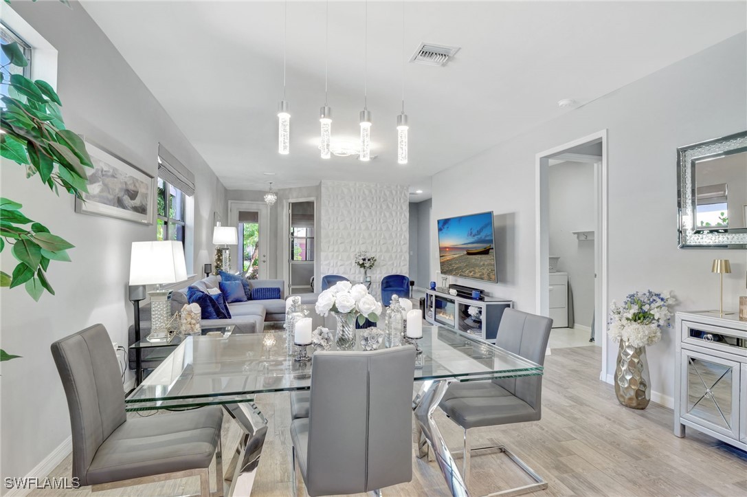 10908 Clarendon Street Fort Myers, FL 33913 - Photo 11 of 49 a view of a dining room with furniture and wooden floor