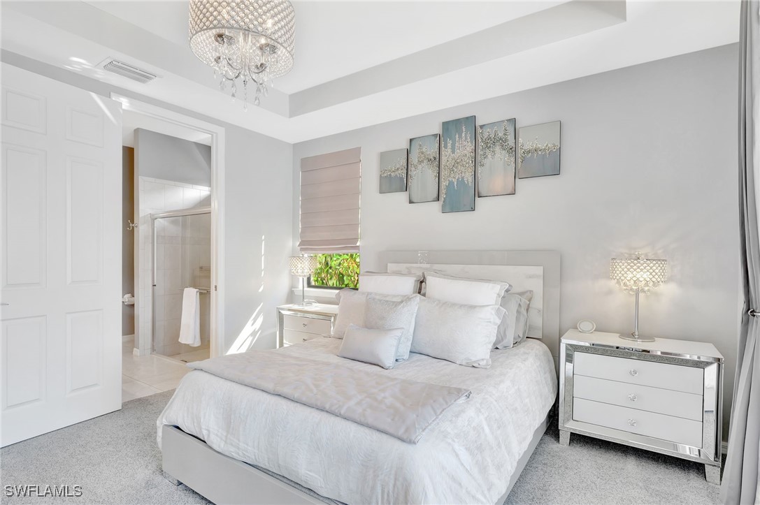 10908 Clarendon Street Fort Myers, FL 33913 - Photo 17 of 49 a bed room with a bed and a chandelier