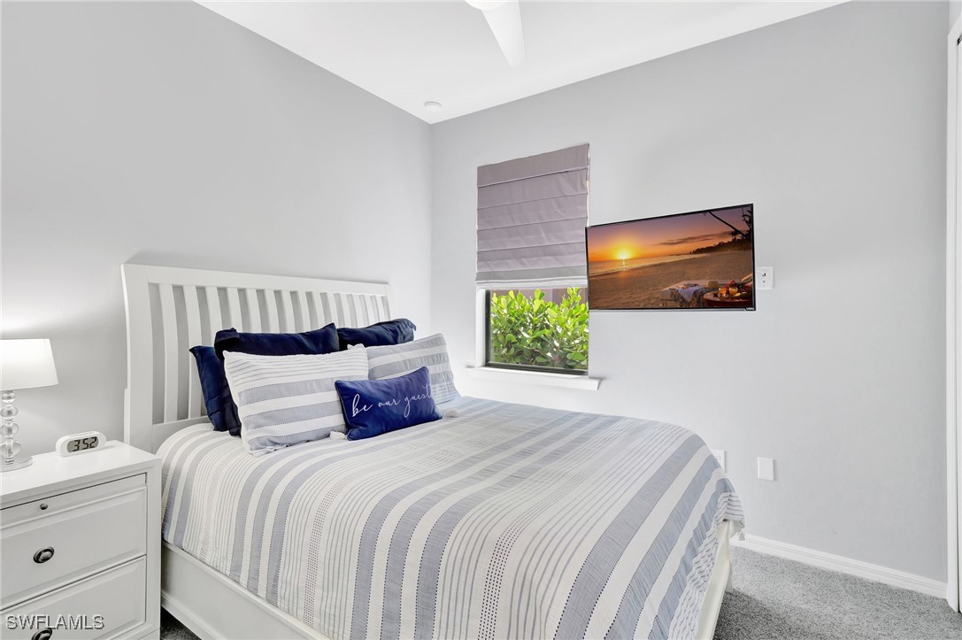 10908 Clarendon Street Fort Myers, FL 33913 - Photo 22 of 49 a bedroom with a bed and a flat screen tv