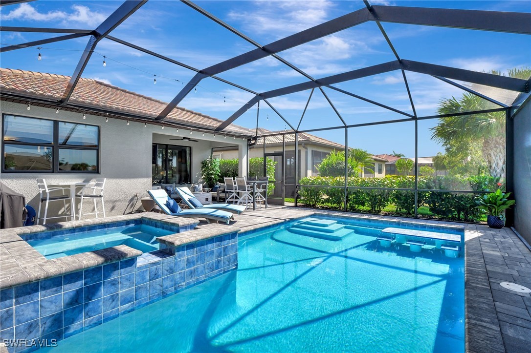 10908 Clarendon Street Fort Myers, FL 33913 - Photo 32 of 49 a view of a backyard with table and chairs under an umbrella
