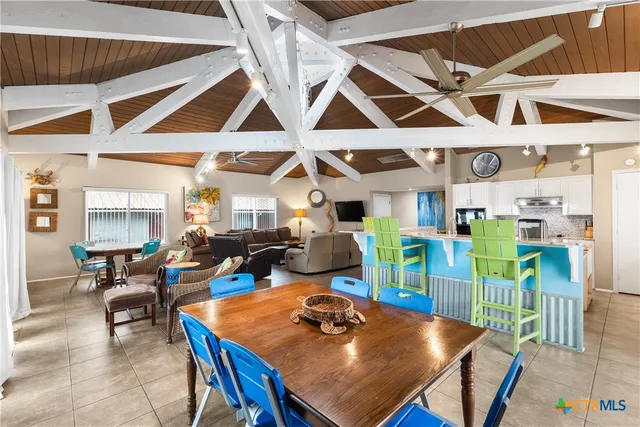 a view of a dining hall with a table and chairs