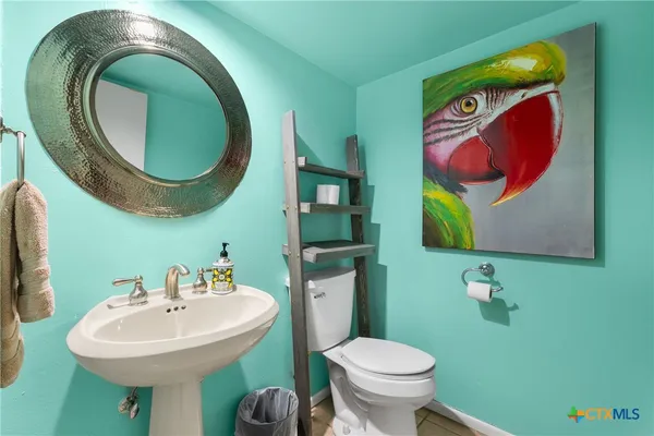 a bathroom with a toilet sink and mirror
