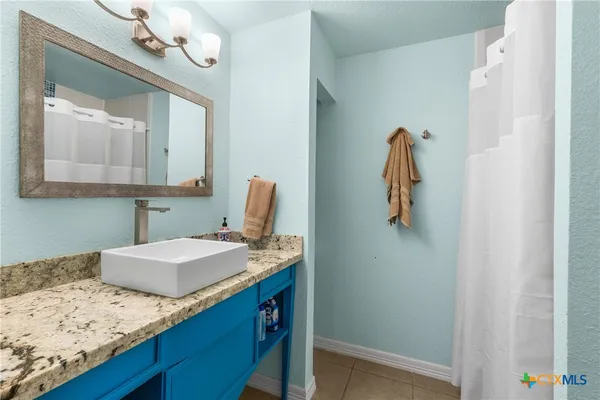 a bathroom with a sink vanity and a mirror