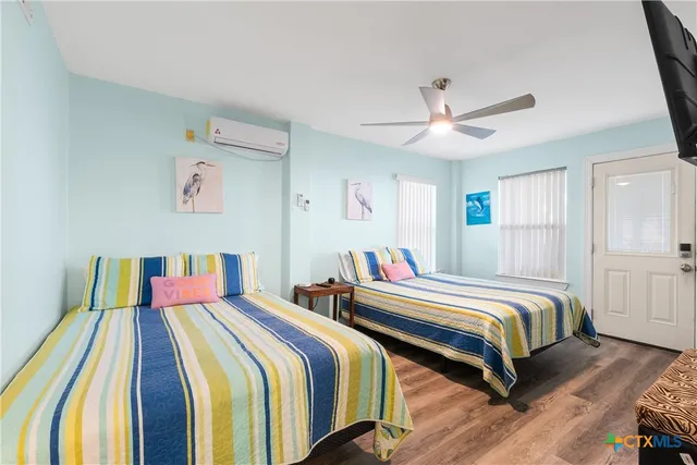 a bedroom with two beds and a chandelier