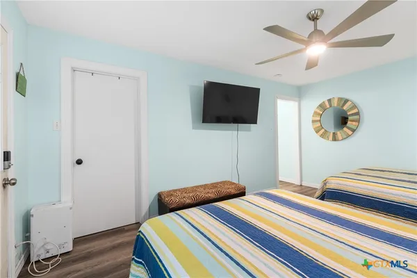 a bedroom with bed and a flat screen tv