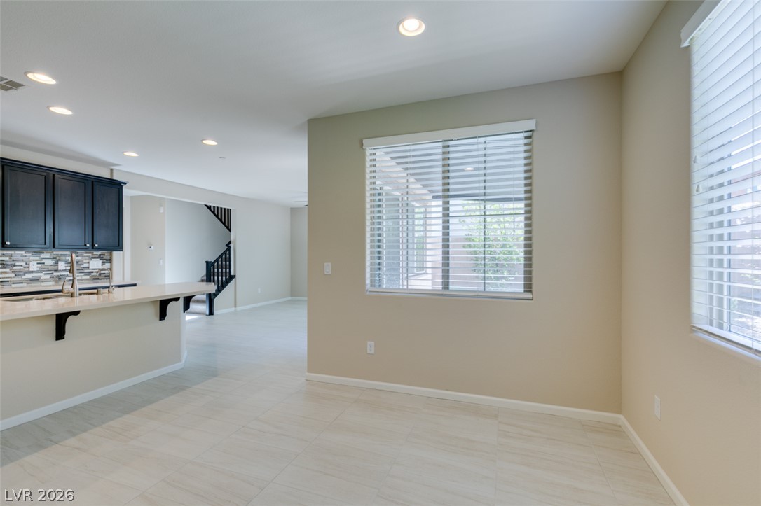 2549 Sable Ridge Street Henderson, NV 89044 - Photo 22 of 48 A well-lit, open-concept living space seamlessly connects the kitchen with dining and lounge areas.