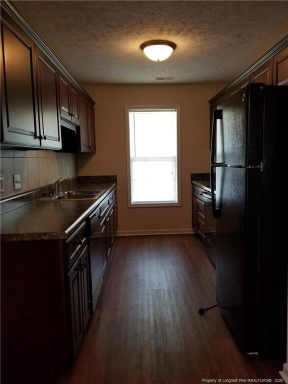 2402 7th Street Road, Unit B Lumberton, NC 28358 - Photo 4 of 10 a kitchen that has a sink wooden cabinets and stainless steel appliances