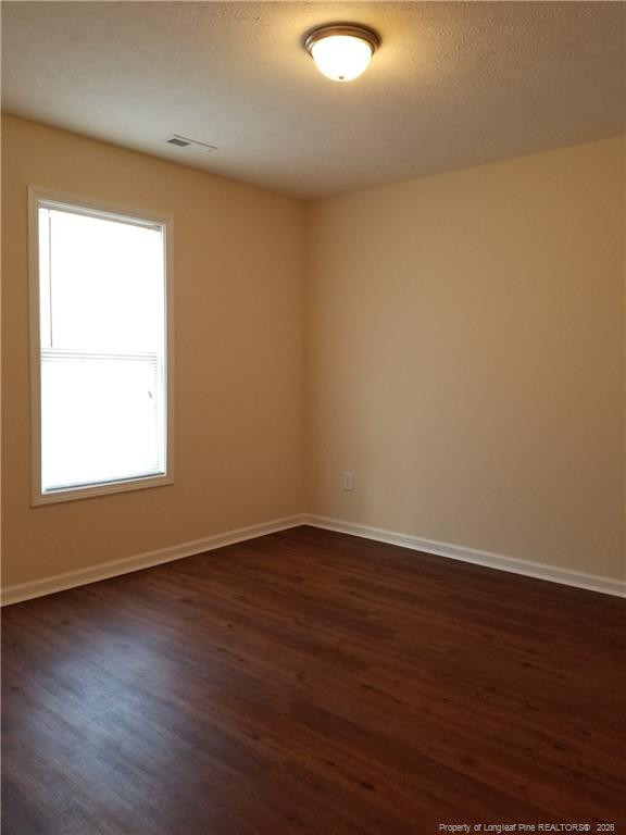 2402 7th Street Road, Unit B Lumberton, NC 28358 - Photo 6 of 10 an empty room with wooden floor and windows