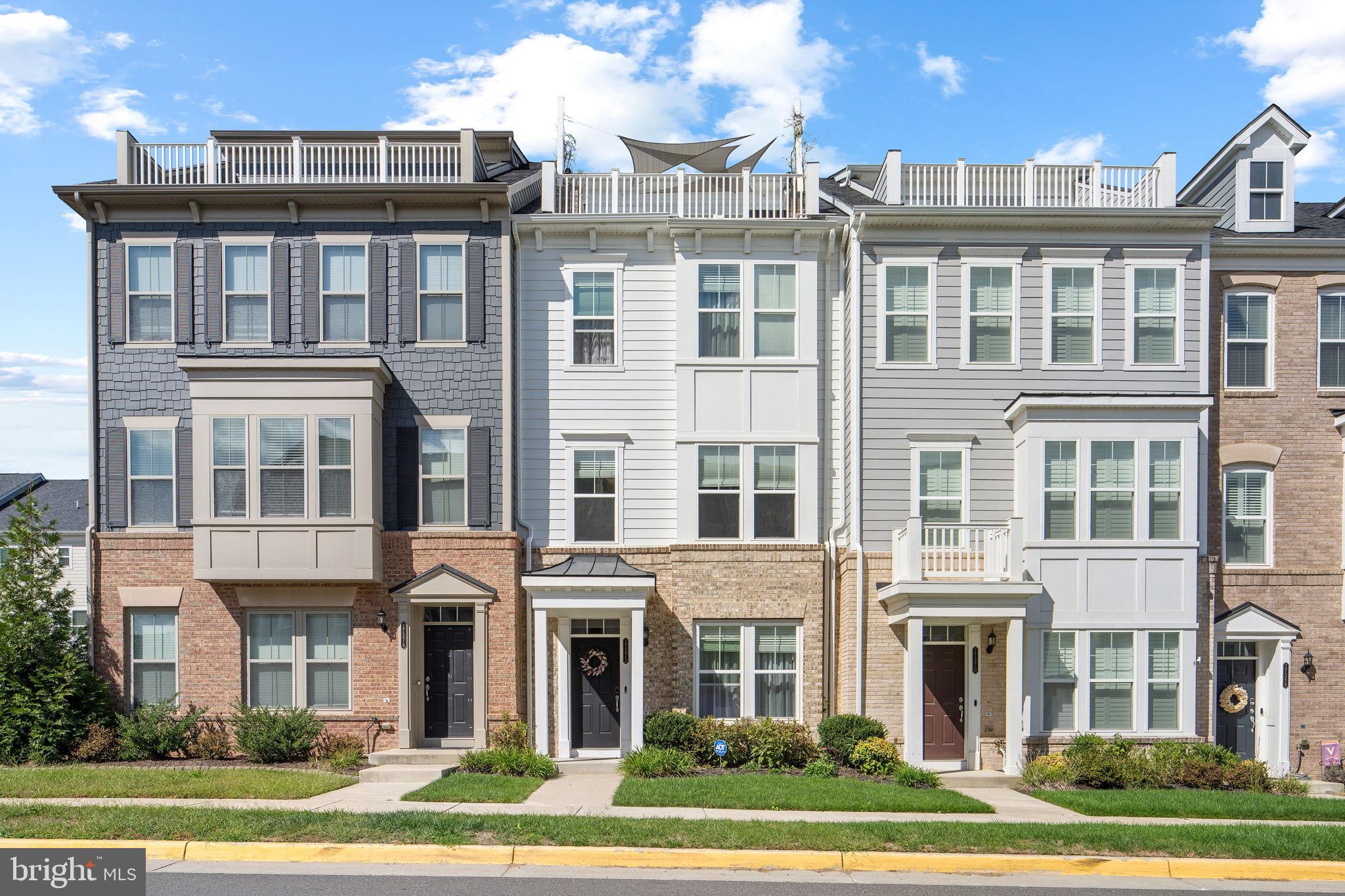a front view of a residential apartment building with a yard