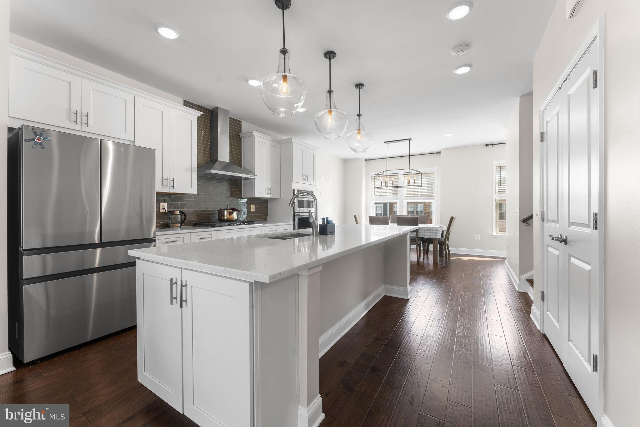 17372 Redshank Road Dumfries, VA 22026 - Photo 12 of 51 a kitchen with stainless steel appliances a refrigerator a sink dishwasher a oven a stove and white cabinets with wooden floor