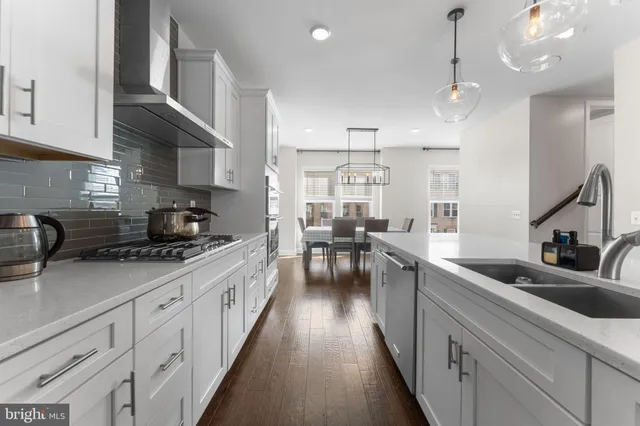 a kitchen with kitchen island granite countertop lots of counter space a sink appliances and cabinets