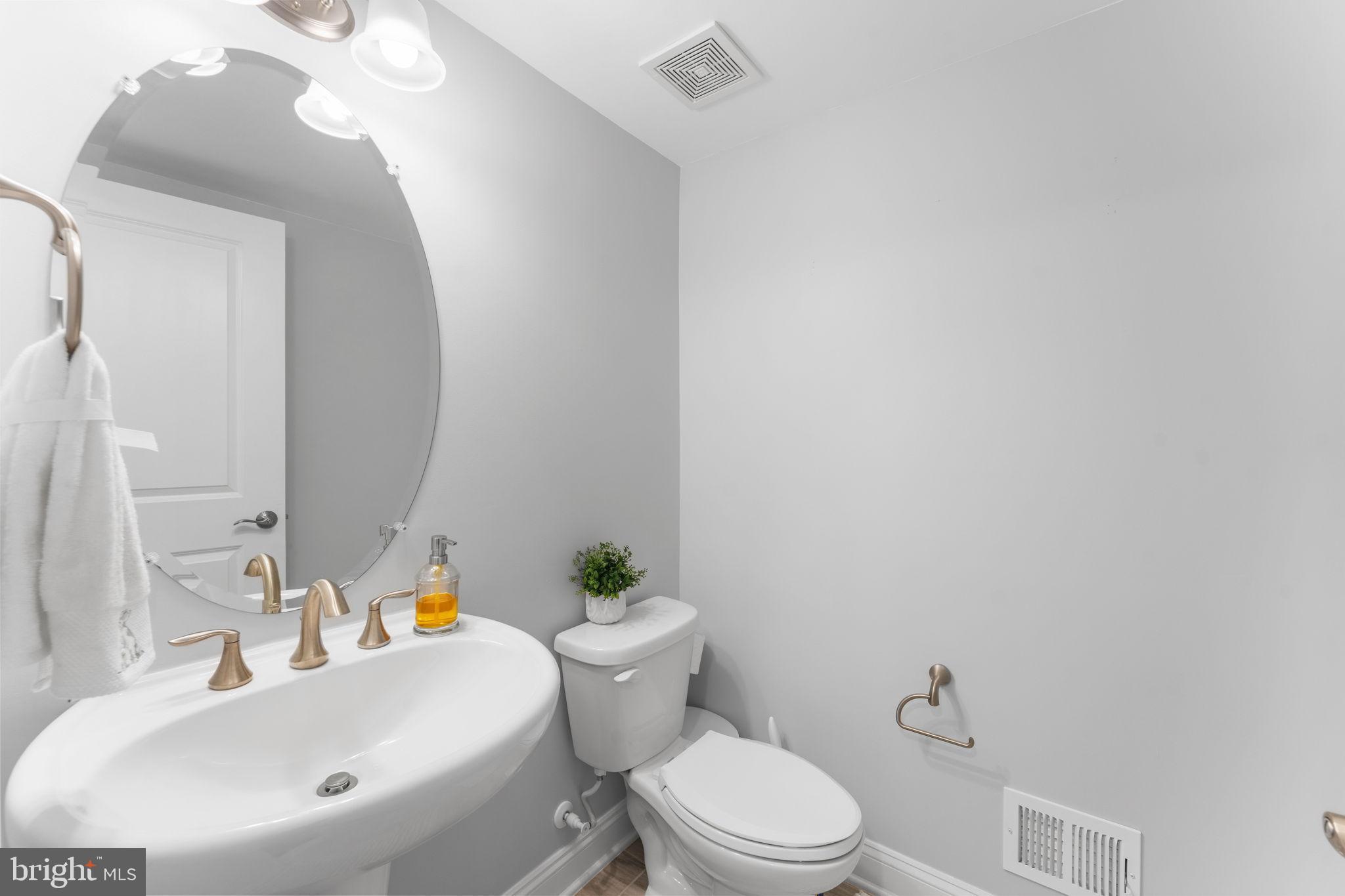 17372 Redshank Road Dumfries, VA 22026 - Photo 19 of 51 a bathroom with a sink a toilet and a mirror