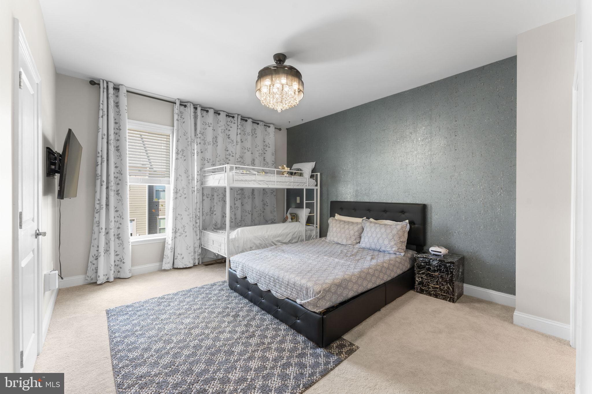 17372 Redshank Road Dumfries, VA 22026 - Photo 20 of 51 a bedroom with a large bed and a chandelier