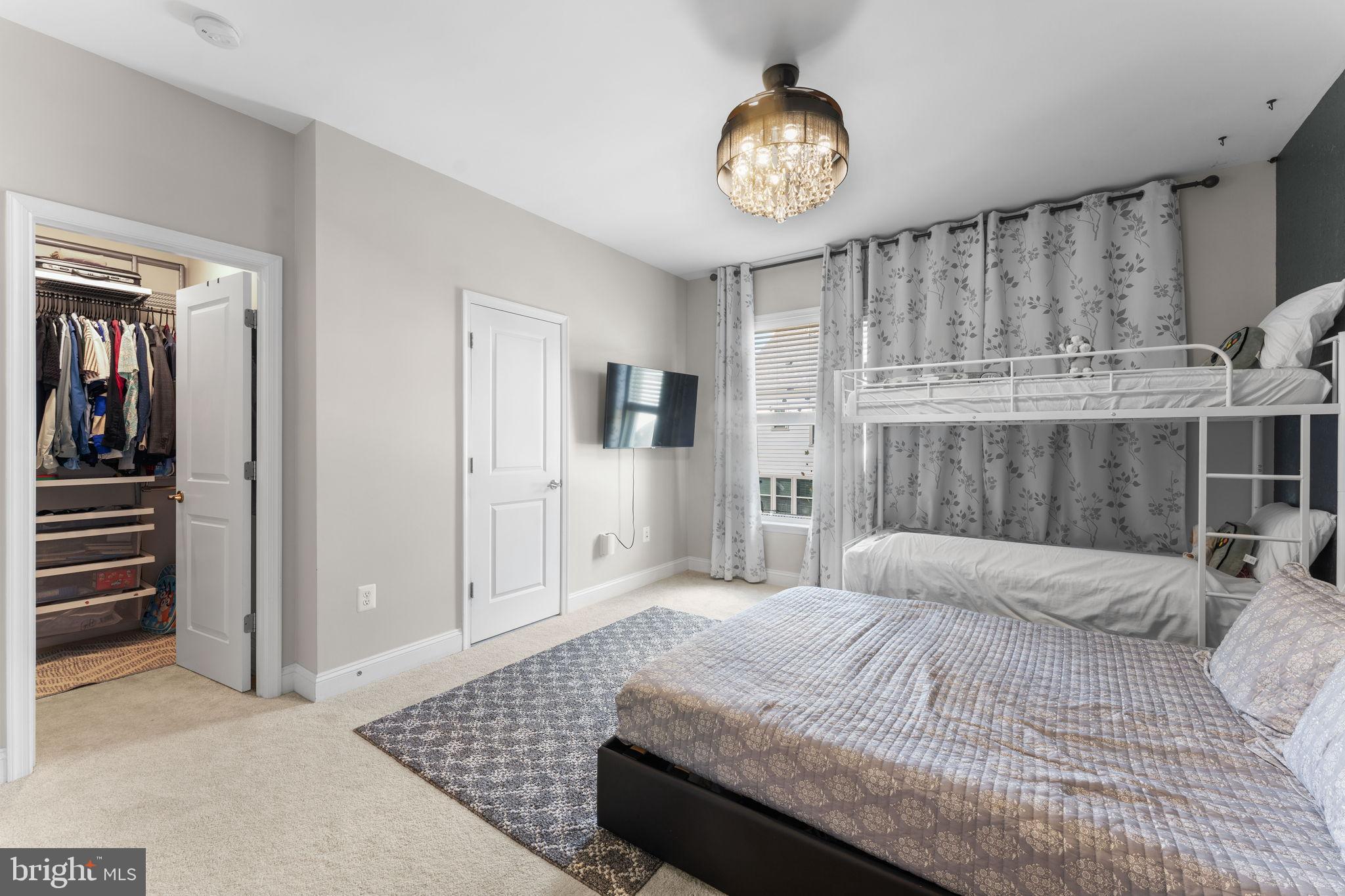 17372 Redshank Road Dumfries, VA 22026 - Photo 22 of 51 a bedroom with a large bed and a chandelier