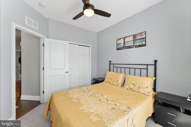 a bedroom with a bed and a chair in it