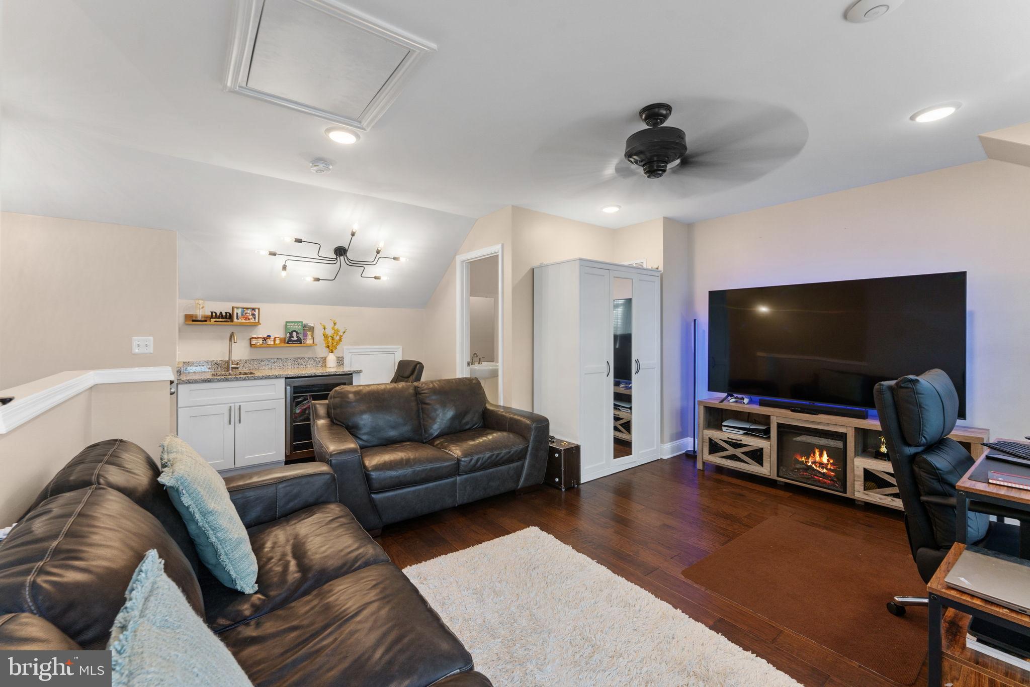 17372 Redshank Road Dumfries, VA 22026 - Photo 35 of 51 a living room with furniture and a flat screen tv