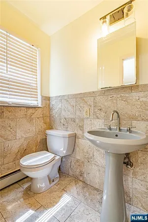 a bathroom with a sink toilet and mirror