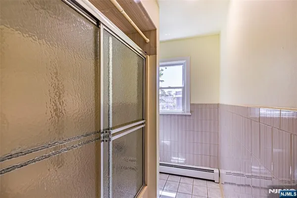 a bathroom with a glass door shower