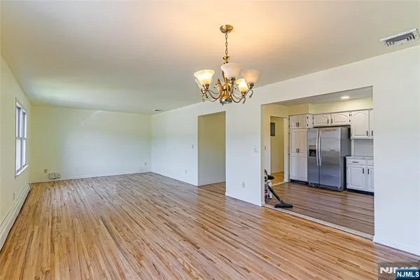 a view of livingroom with chandelier and wooden floor
