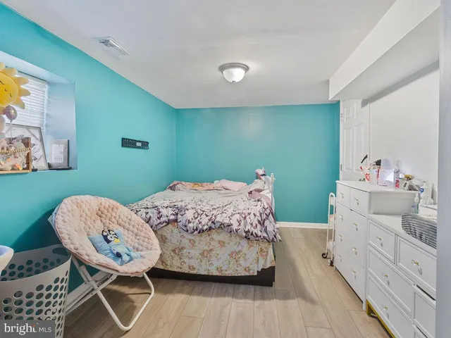 a bedroom with a bed a table and chair