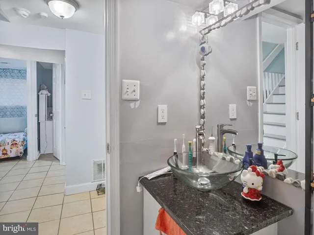 a kitchen with a granite countertop sink and cabinets