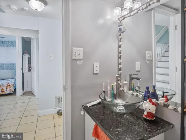 a kitchen with a granite countertop sink and cabinets