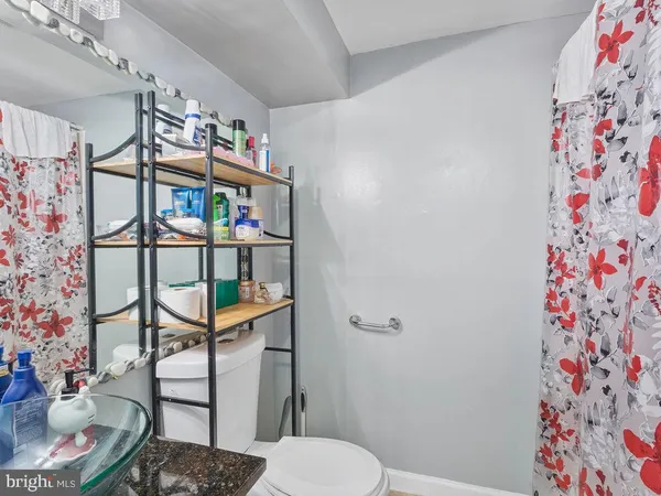 a bathroom with a toilet and a shower curtain