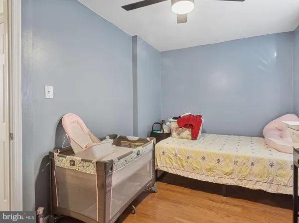 a white bed sitting in a bedroom next to a window