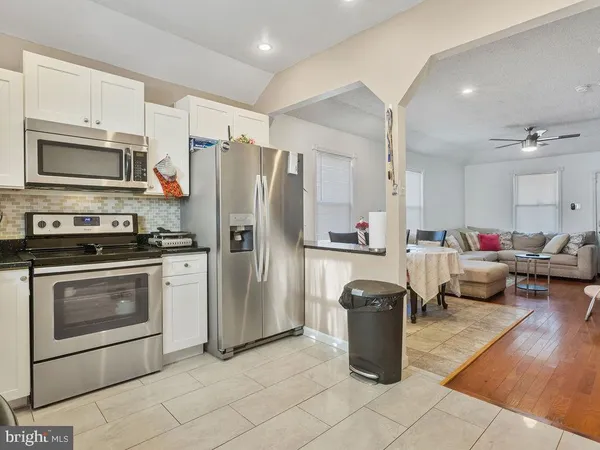 a kitchen with a refrigerator stove and a sink